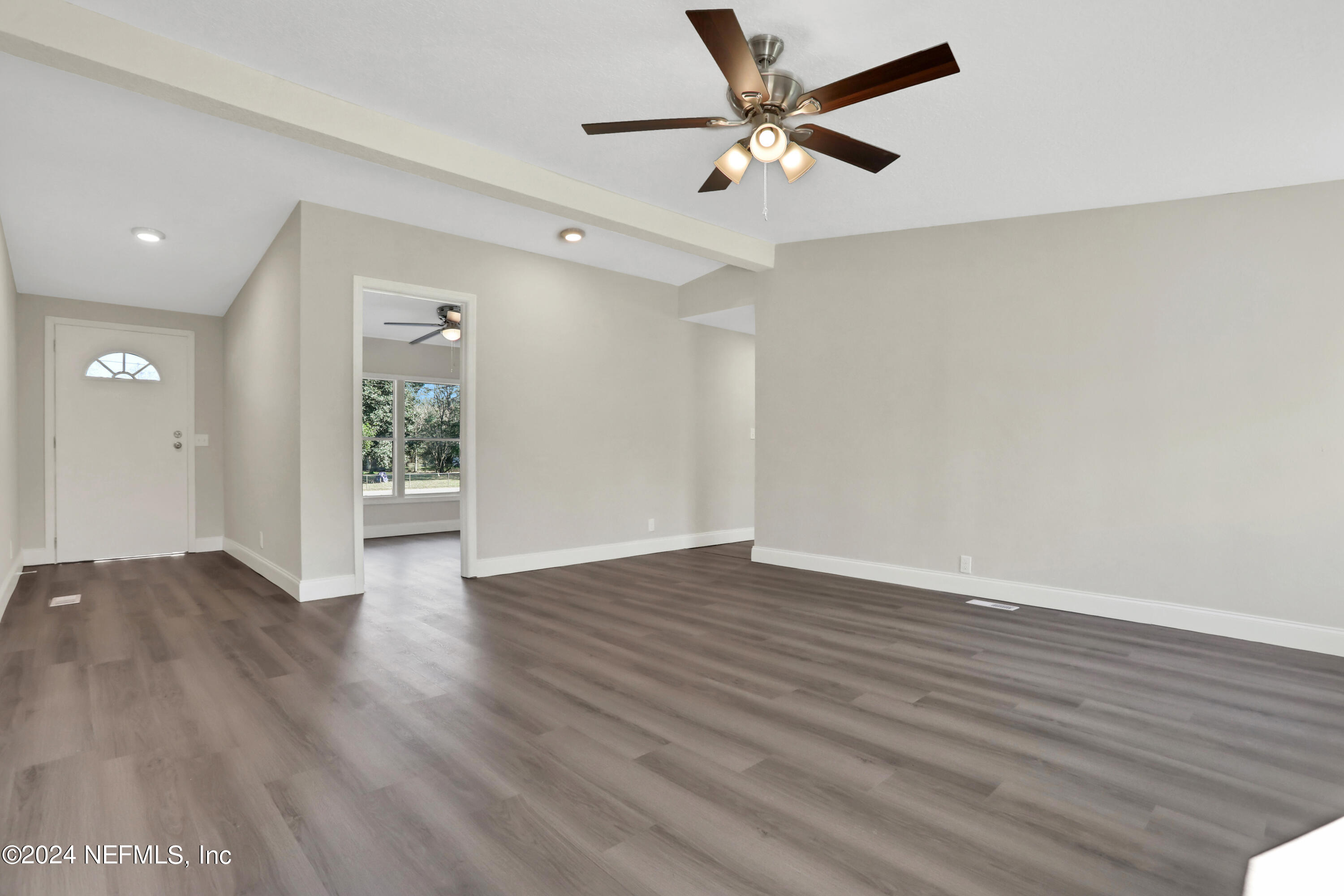54057 Bea Road Callahan, FL 32011 - Photo 4 of 29 a view of an empty room with wooden floor
