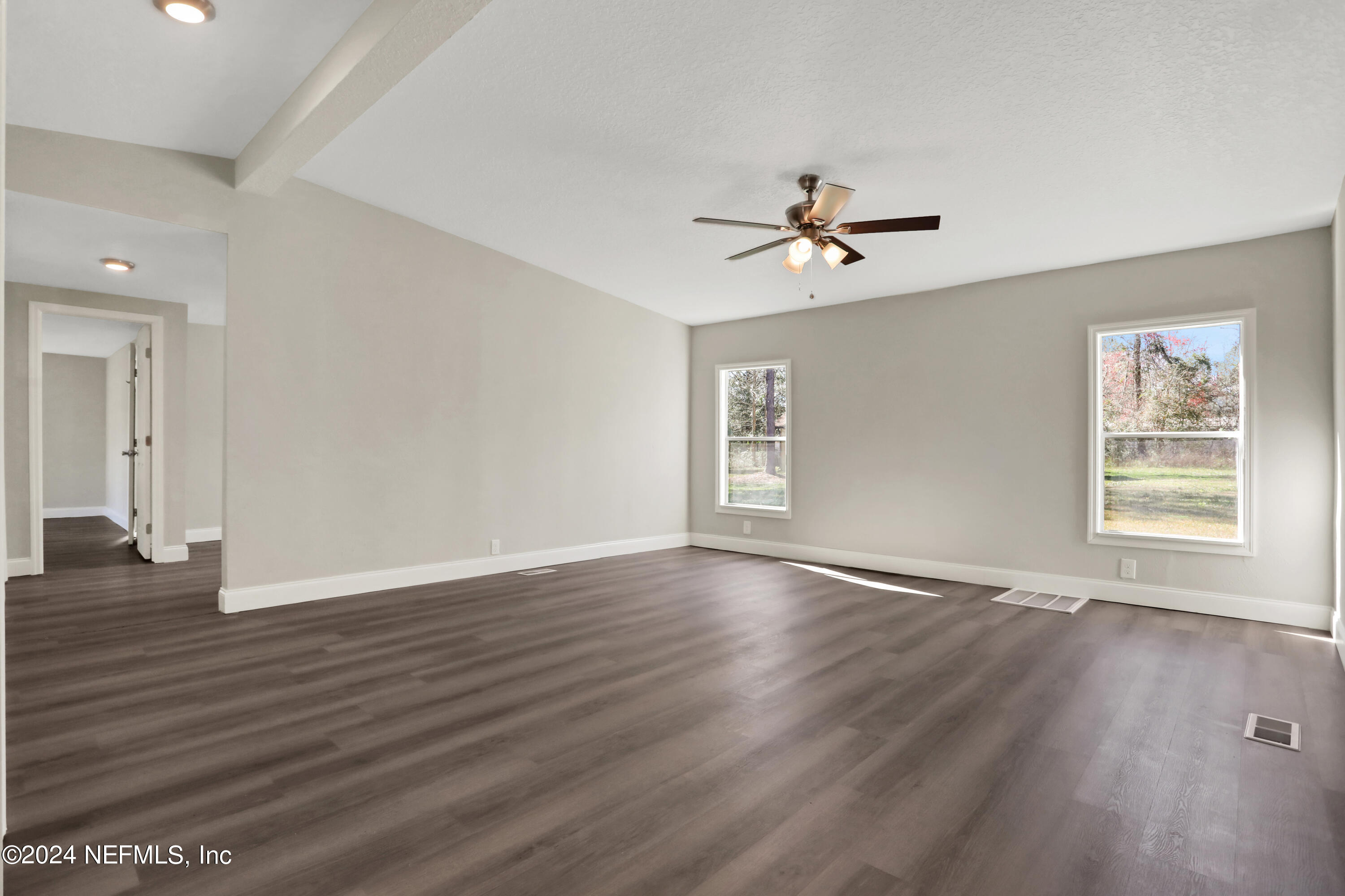 54057 Bea Road Callahan, FL 32011 - Photo 5 of 29 a view of an empty room with a window and wooden floor