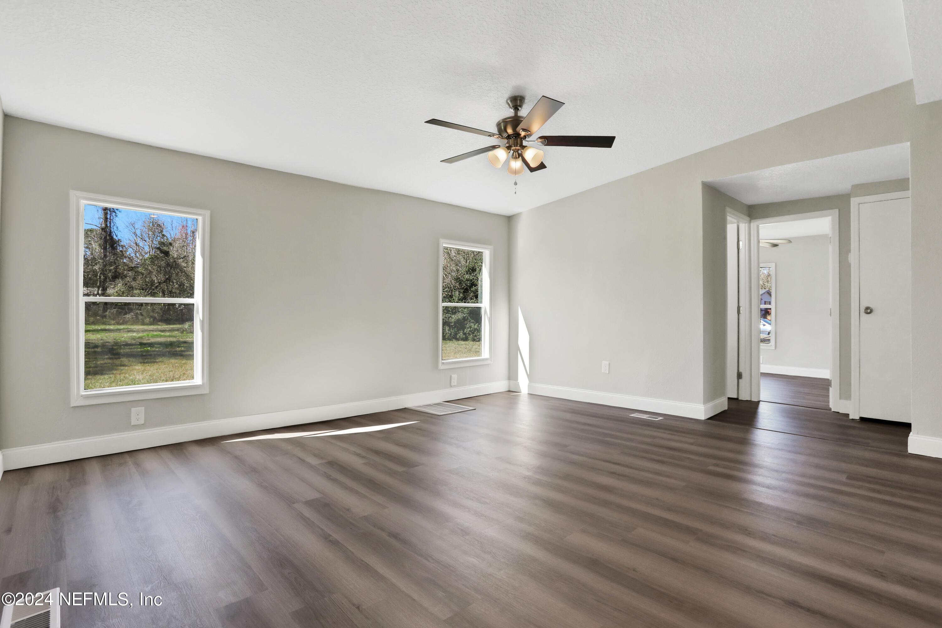 54057 Bea Road Callahan, FL 32011 - Photo 6 of 29 a view of an empty room with wooden floor and a window