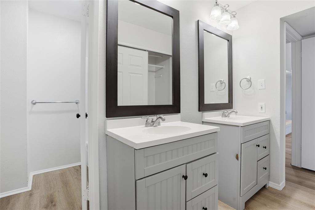 403 Redbud Drive Forney, TX 75126 - Photo 14 of 17 a bathroom with a sink and a mirror