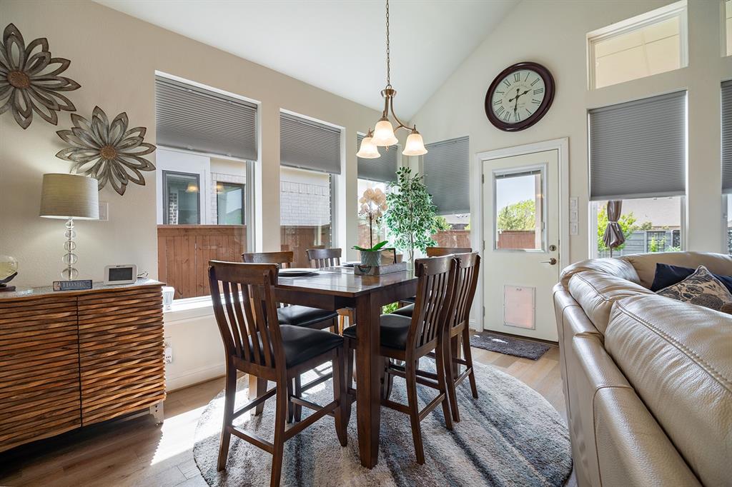 1213 Sea Island Road Aubrey, TX 76227 - Photo 14 of 36 Charming breakfast nook filled with natural light, seamlessly connecting to the kitchen, with a back door to the yard featuring a convenient doggy door.