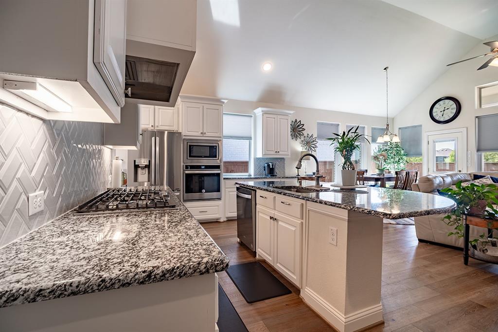 1213 Sea Island Road Aubrey, TX 76227 - Photo 16 of 36 Spacious kitchen island with stunning granite countertops, perfect for meal prep and entertaining.