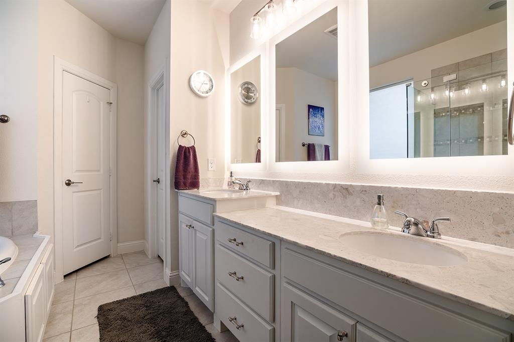 1213 Sea Island Road Aubrey, TX 76227 - Photo 25 of 36 Primary bathroom featuring dual sinks with one raised for convenience and a stylish, functional layout