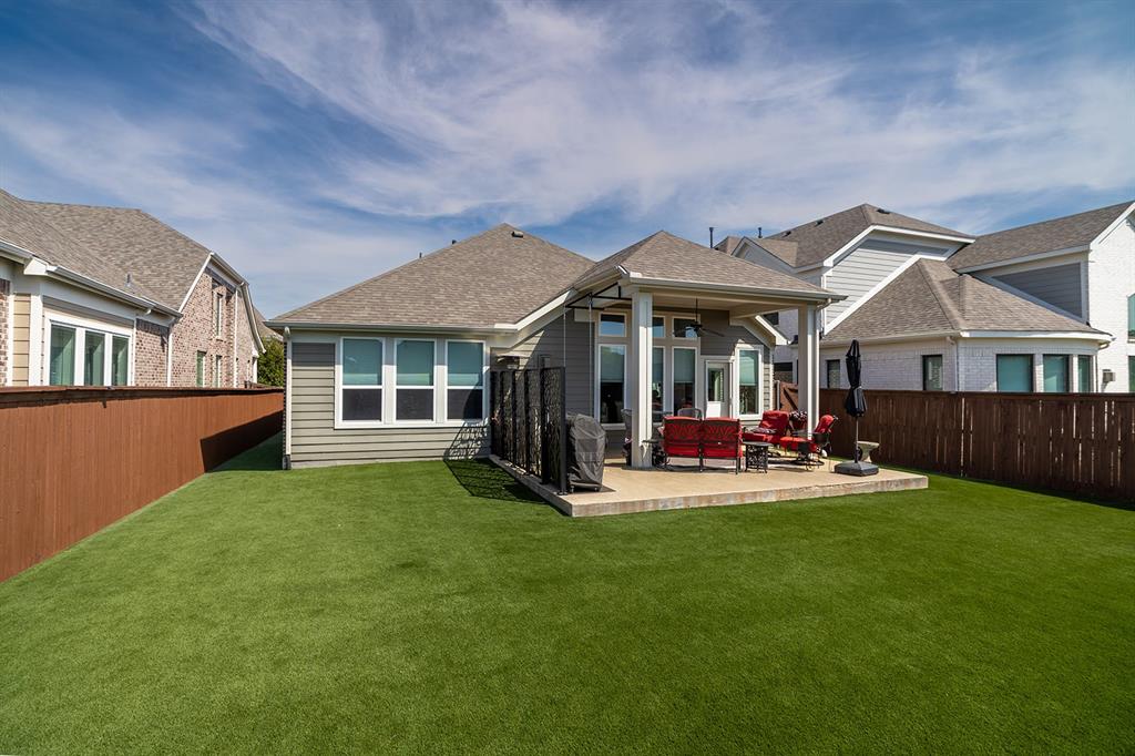 1213 Sea Island Road Aubrey, TX 76227 - Photo 33 of 36 Fenced turf backyard with plenty of space for play, pets, and outdoor activities