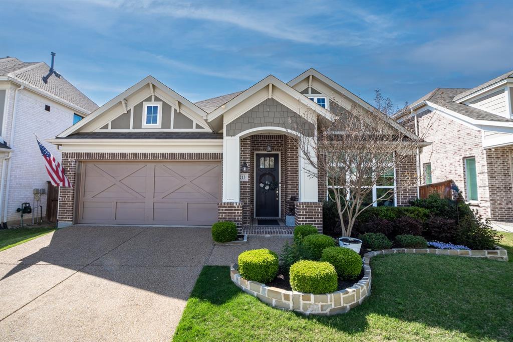 1213 Sea Island Road Aubrey, TX 76227 - Photo 5 of 36 Lush, professionally landscaped yard with vibrant greenery and eye-catching curb appeal