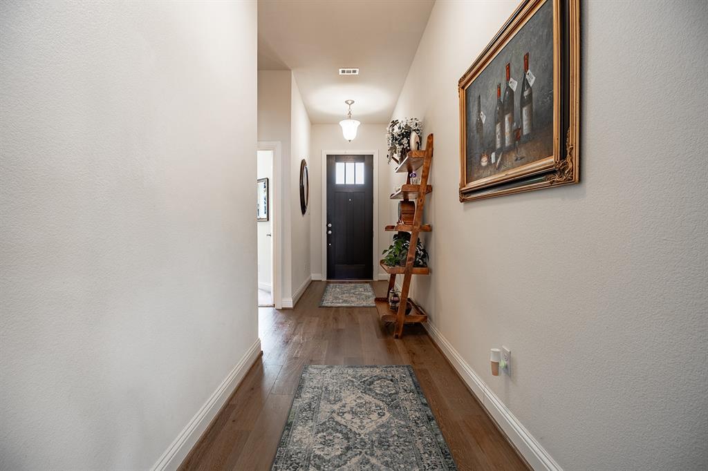 1213 Sea Island Road Aubrey, TX 76227 - Photo 7 of 36 Inviting entryway with a straight walk to the open living area and chef-ready kitchen