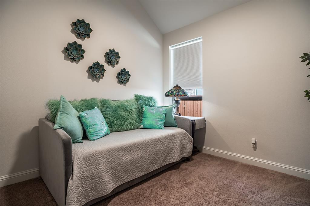 1213 Sea Island Road Aubrey, TX 76227 - Photo 9 of 36 Cozy guest room one with ample natural light and a welcoming, comfortable vibe