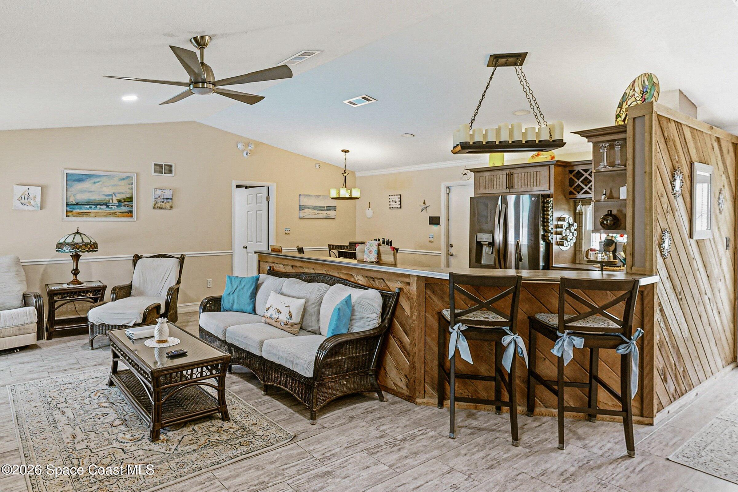 413 Orlov Road Northwest Palm Bay, FL 32907 - Photo 12 of 63 a living room with a couch and a table