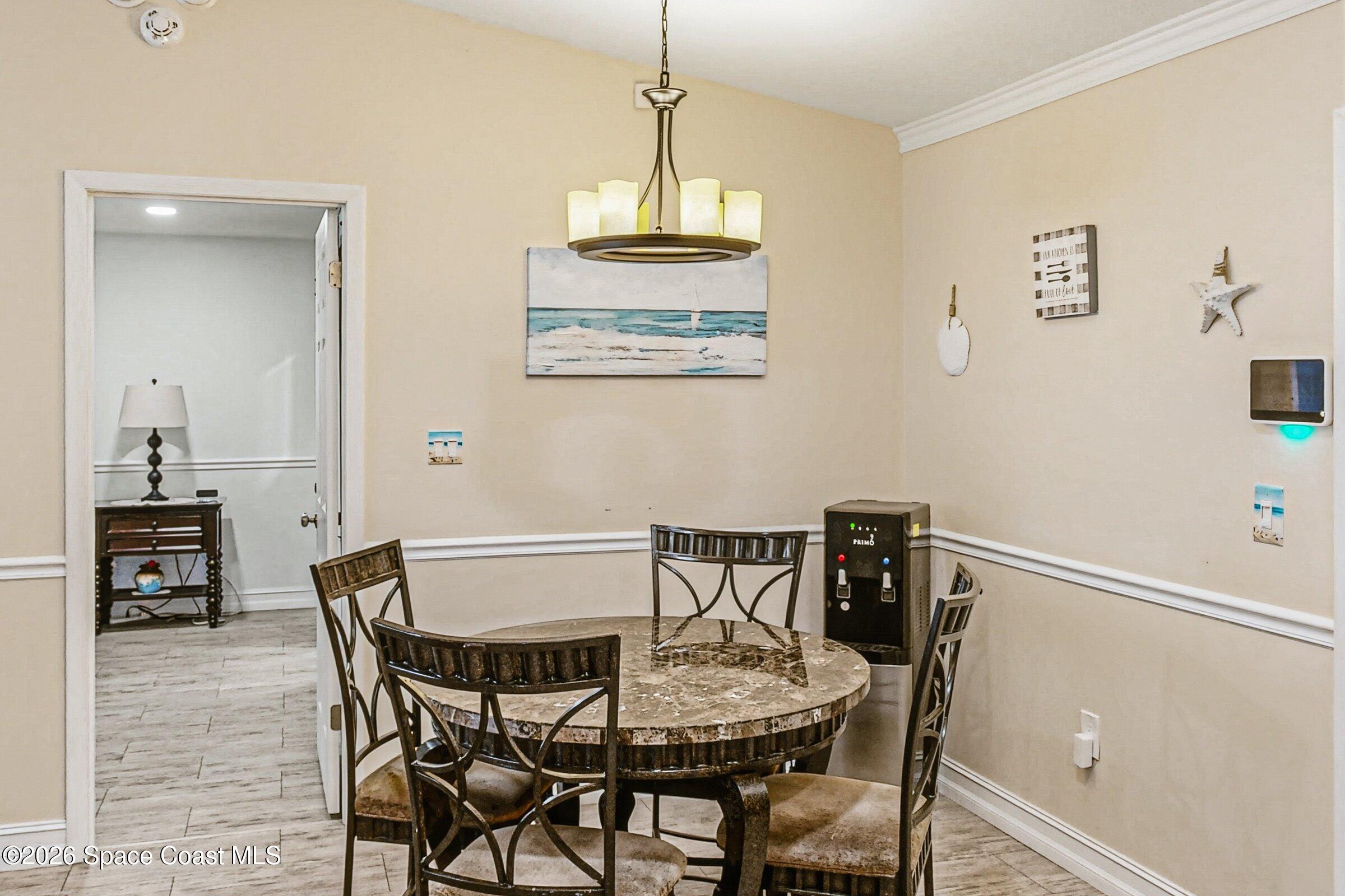 413 Orlov Road Northwest Palm Bay, FL 32907 - Photo 13 of 63 a view of a dining room with furniture and wooden floor