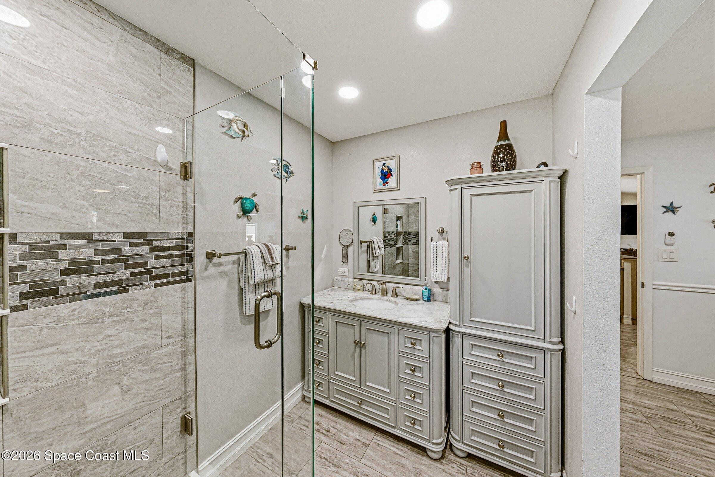 413 Orlov Road Northwest Palm Bay, FL 32907 - Photo 20 of 63 a bathroom with a shower sink and mirror
