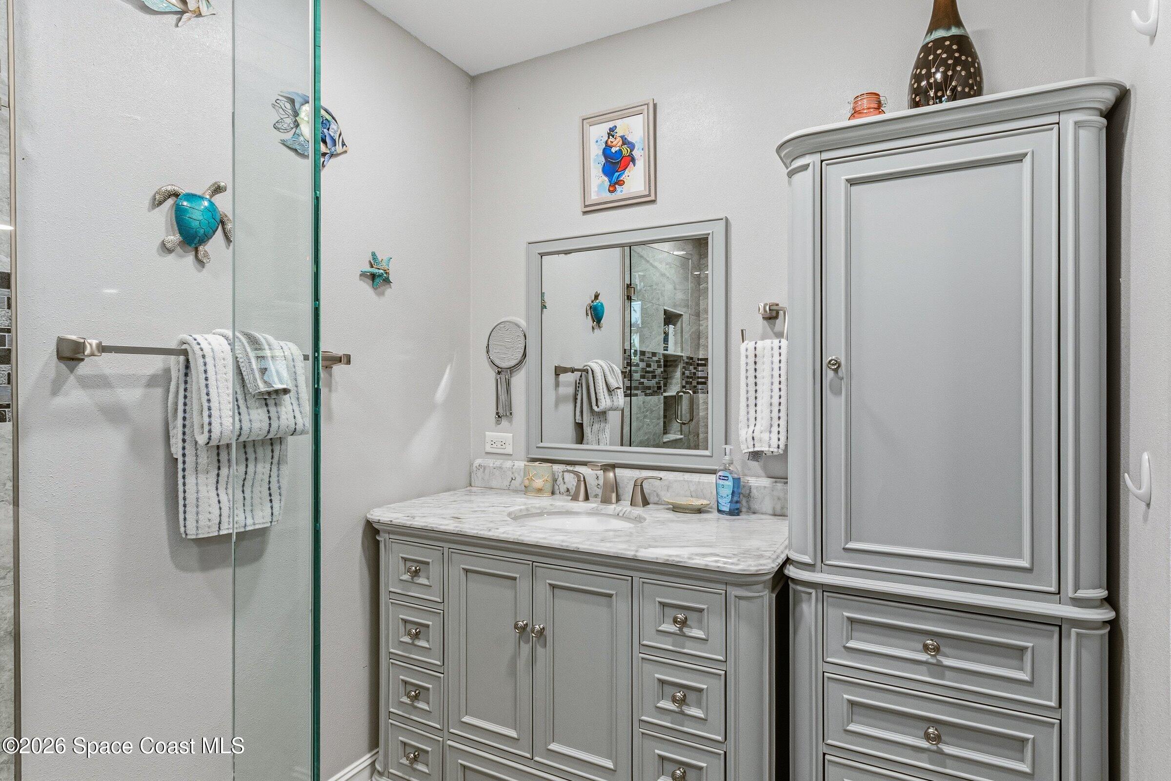 413 Orlov Road Northwest Palm Bay, FL 32907 - Photo 22 of 63 a bathroom with a granite countertop sink and a mirror