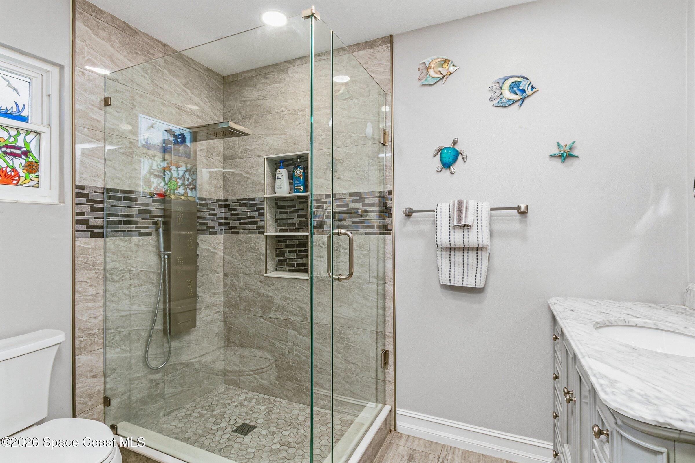 413 Orlov Road Northwest Palm Bay, FL 32907 - Photo 23 of 63 a bathroom with a shower and a sink