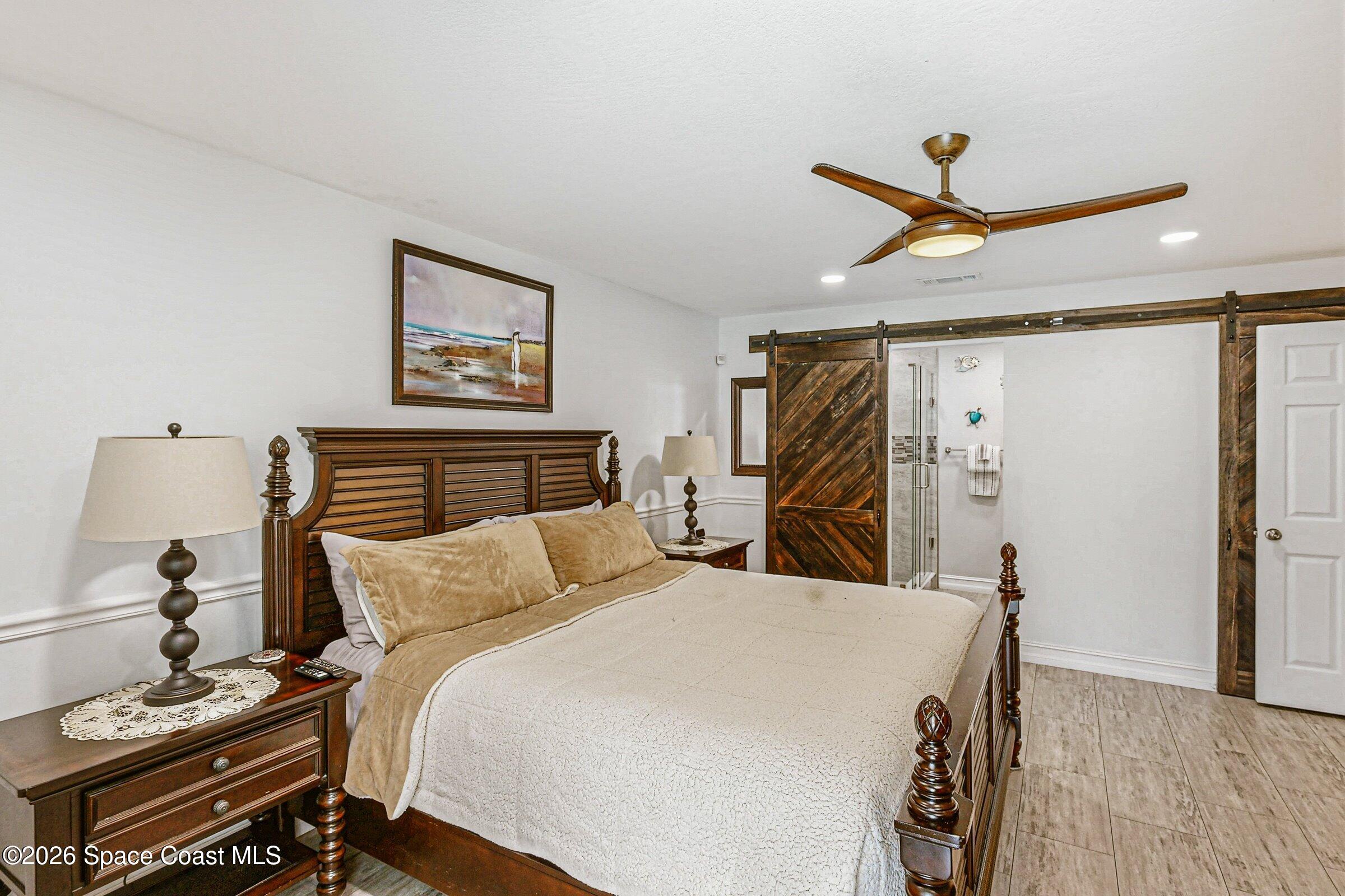 413 Orlov Road Northwest Palm Bay, FL 32907 - Photo 25 of 63 a bedroom with a bed and a dresser