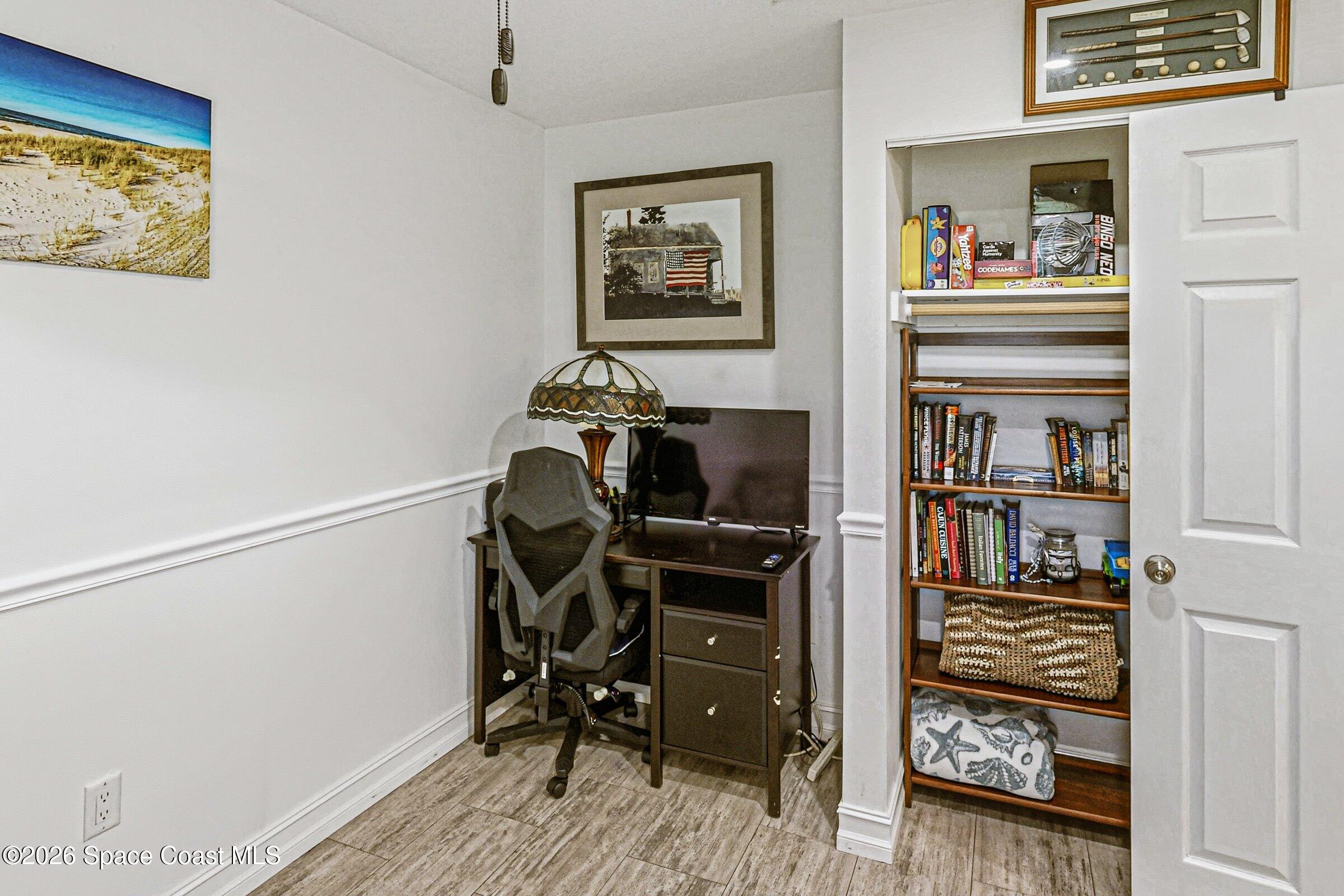 413 Orlov Road Northwest Palm Bay, FL 32907 - Photo 27 of 63 a view of a workspace with furniture and cabinet