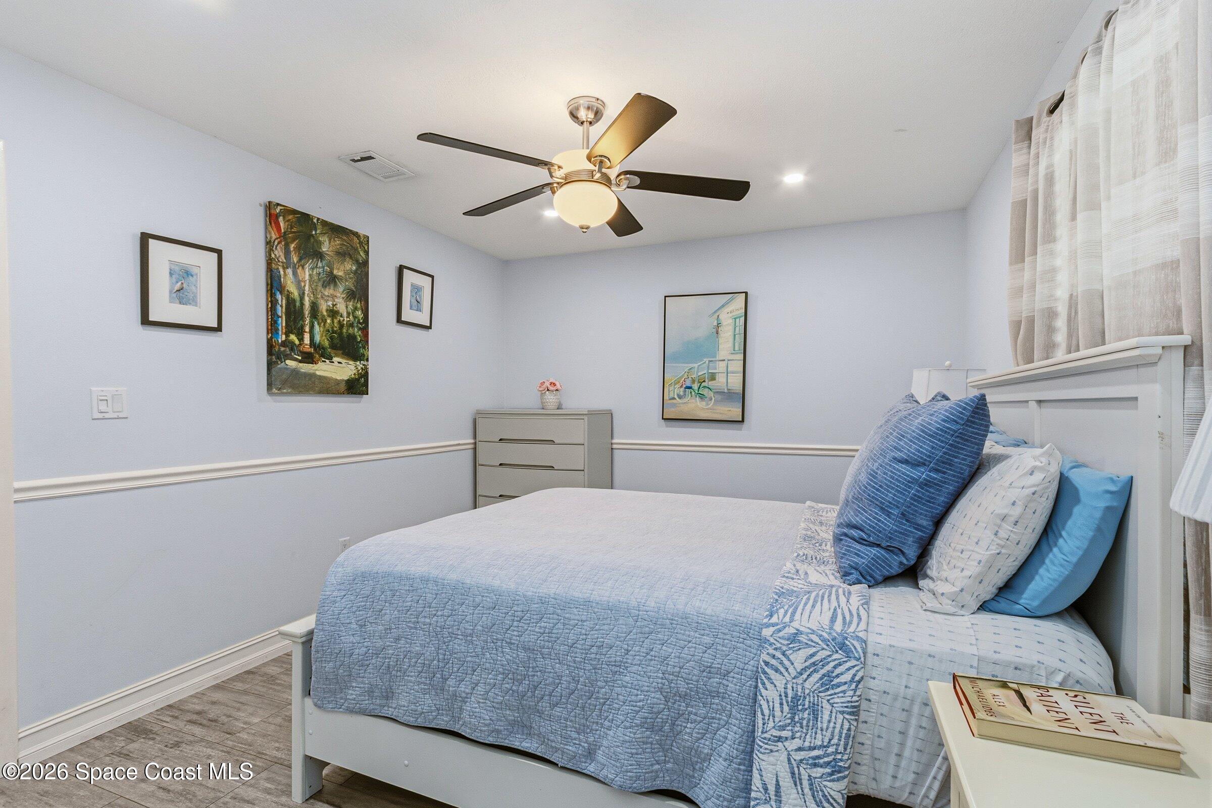 413 Orlov Road Northwest Palm Bay, FL 32907 - Photo 29 of 63 a bedroom with a bed and window