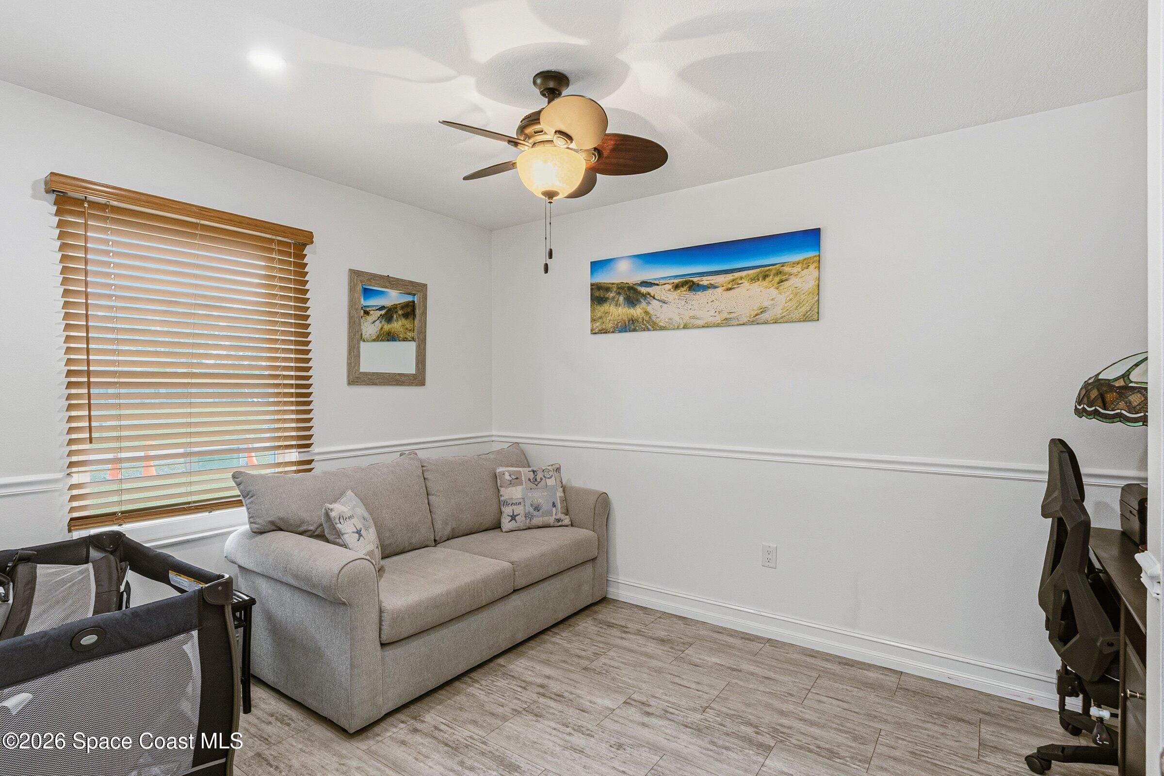 413 Orlov Road Northwest Palm Bay, FL 32907 - Photo 30 of 63 a living room with furniture and a window