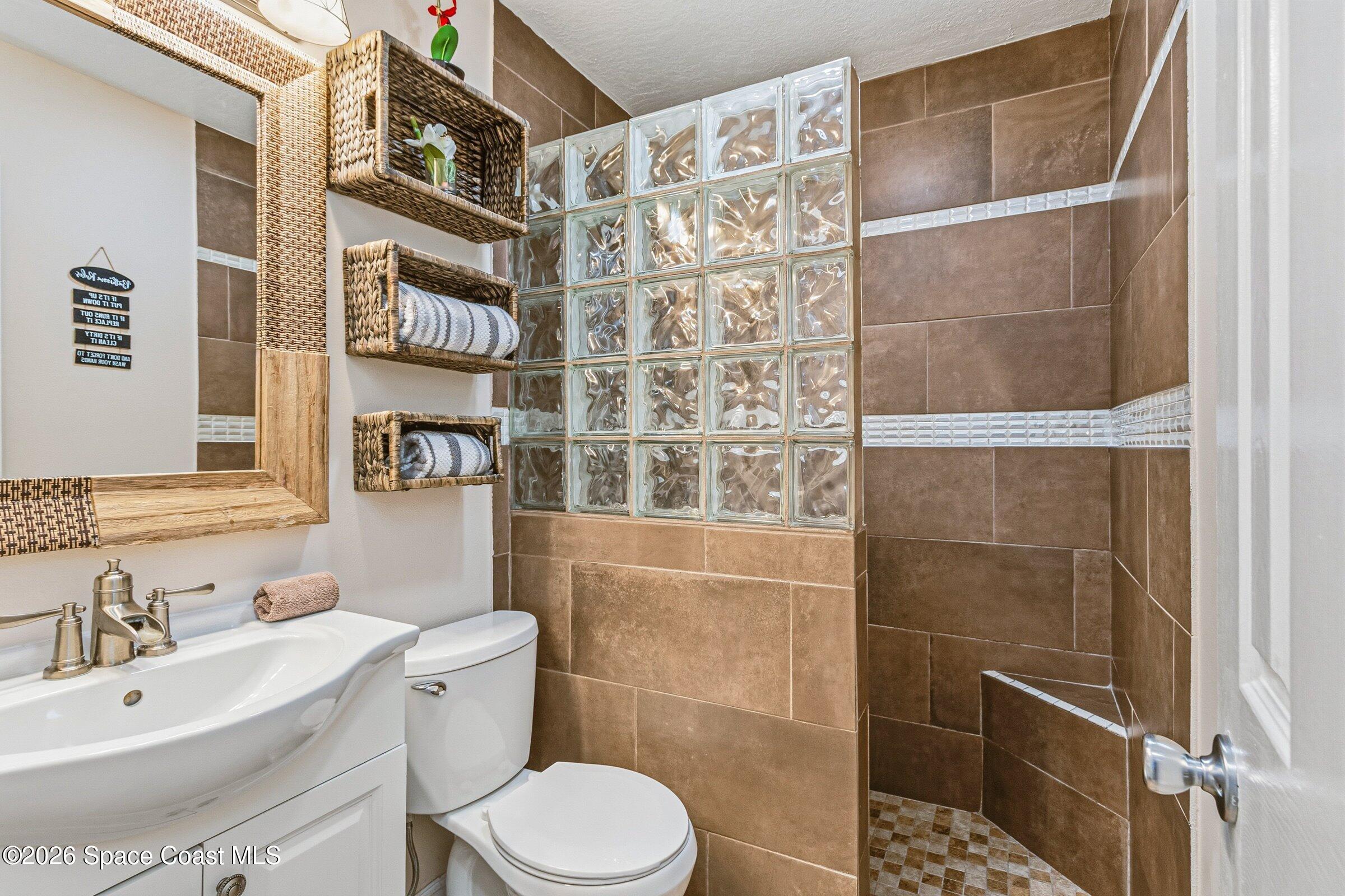 413 Orlov Road Northwest Palm Bay, FL 32907 - Photo 31 of 63 a bathroom with a toilet sink and shower