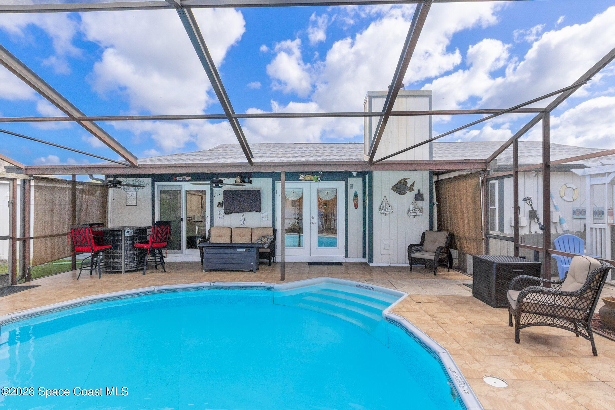 413 Orlov Road Northwest Palm Bay, FL 32907 - Photo 38 of 63 a living room with furniture and a large window