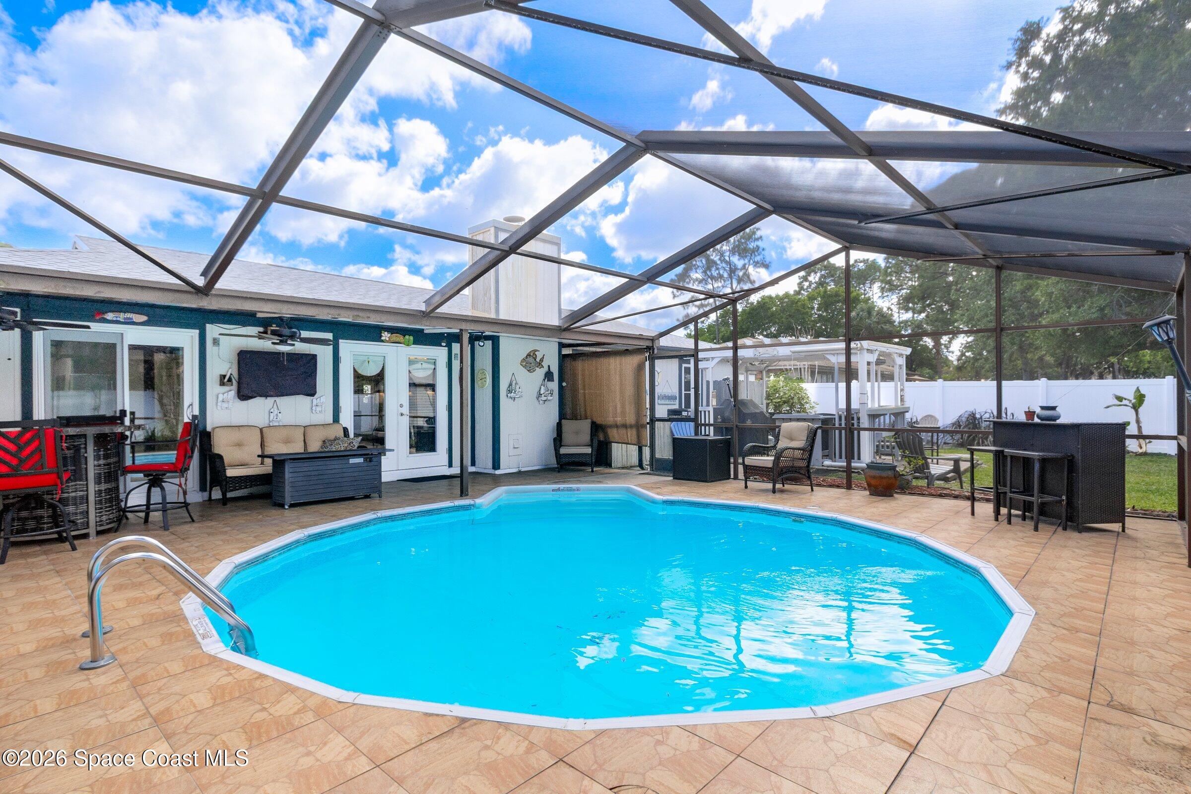 413 Orlov Road Northwest Palm Bay, FL 32907 - Photo 39 of 63 a view of a swimming pool with sitting area