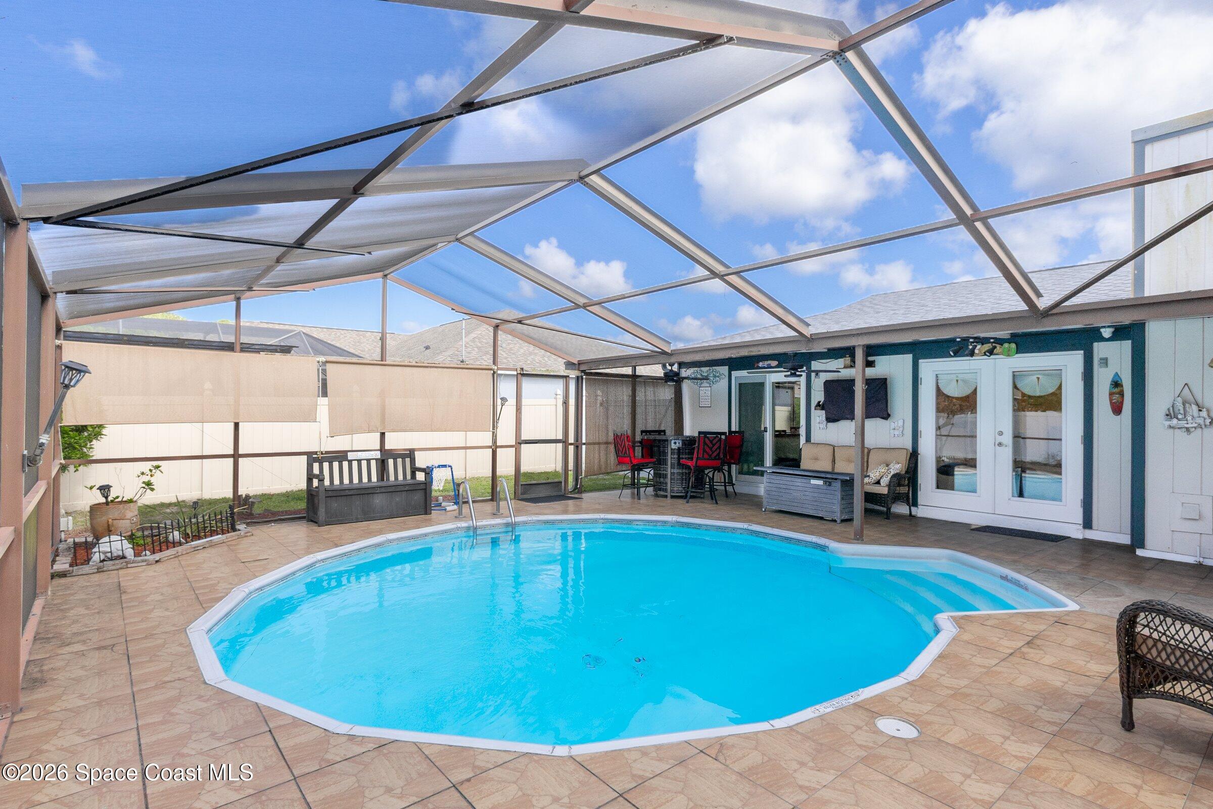 413 Orlov Road Northwest Palm Bay, FL 32907 - Photo 40 of 63 a view of a swimming pool with seating space