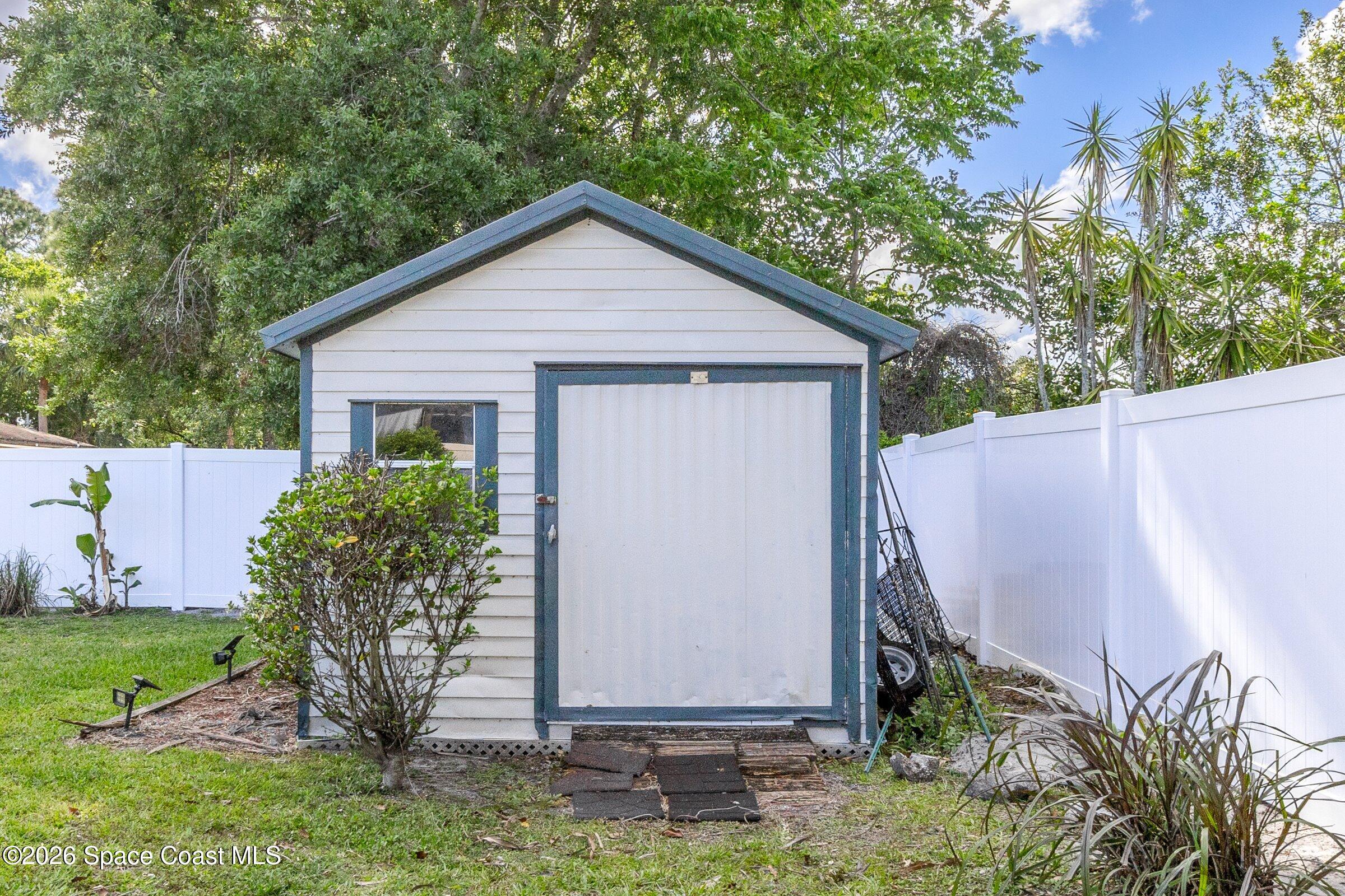 413 Orlov Road Northwest Palm Bay, FL 32907 - Photo 42 of 63 a view of a backyard with plants