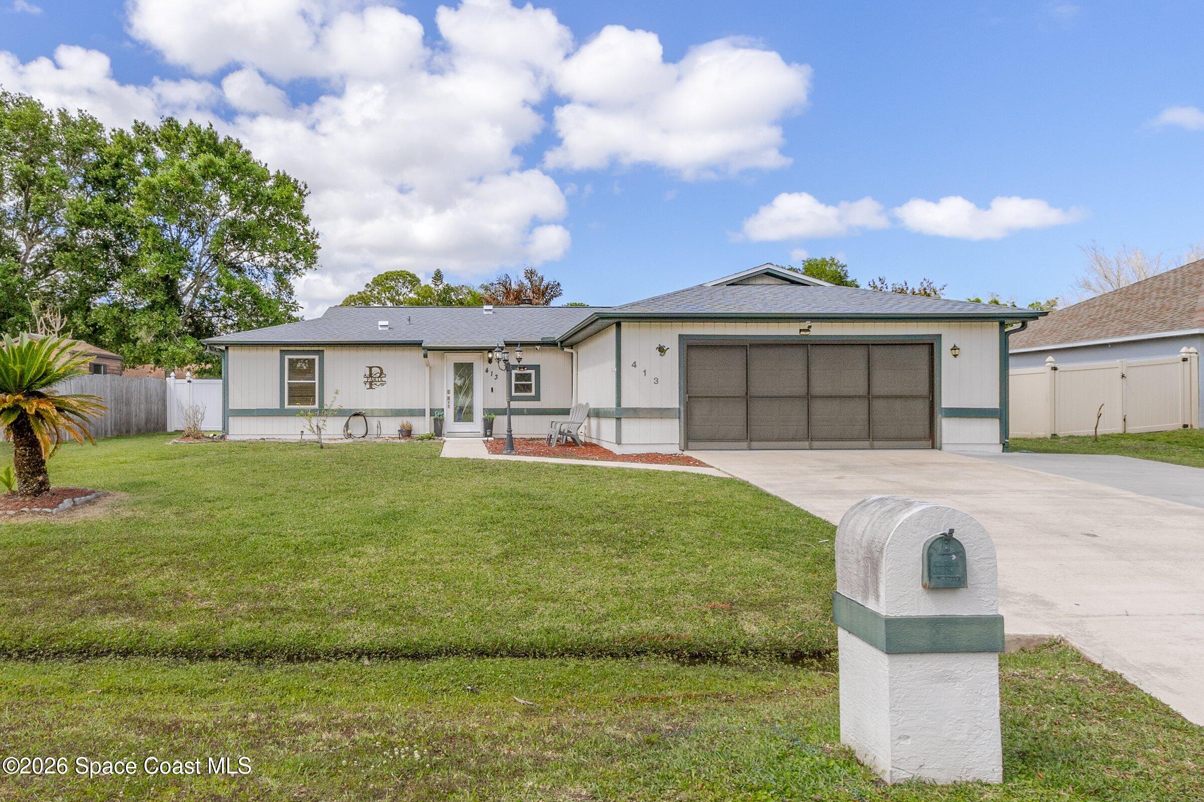413 Orlov Road Northwest Palm Bay, FL 32907 - Photo 45 of 63 a front view of a house with a garden