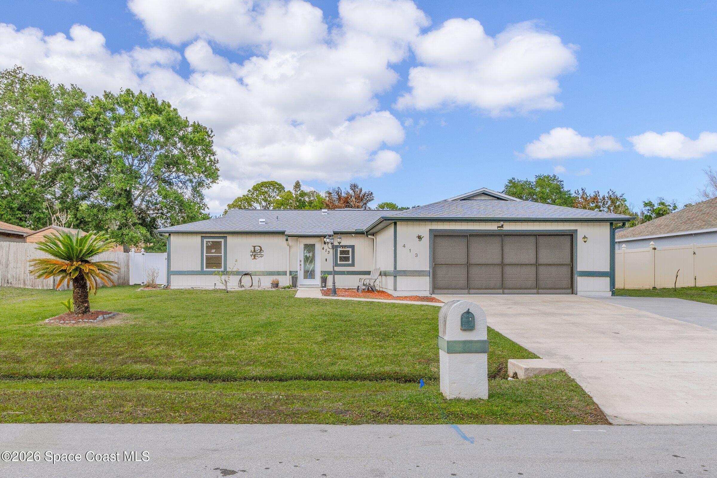 413 Orlov Road Northwest Palm Bay, FL 32907 - Photo 46 of 63 a front view of a house with garden