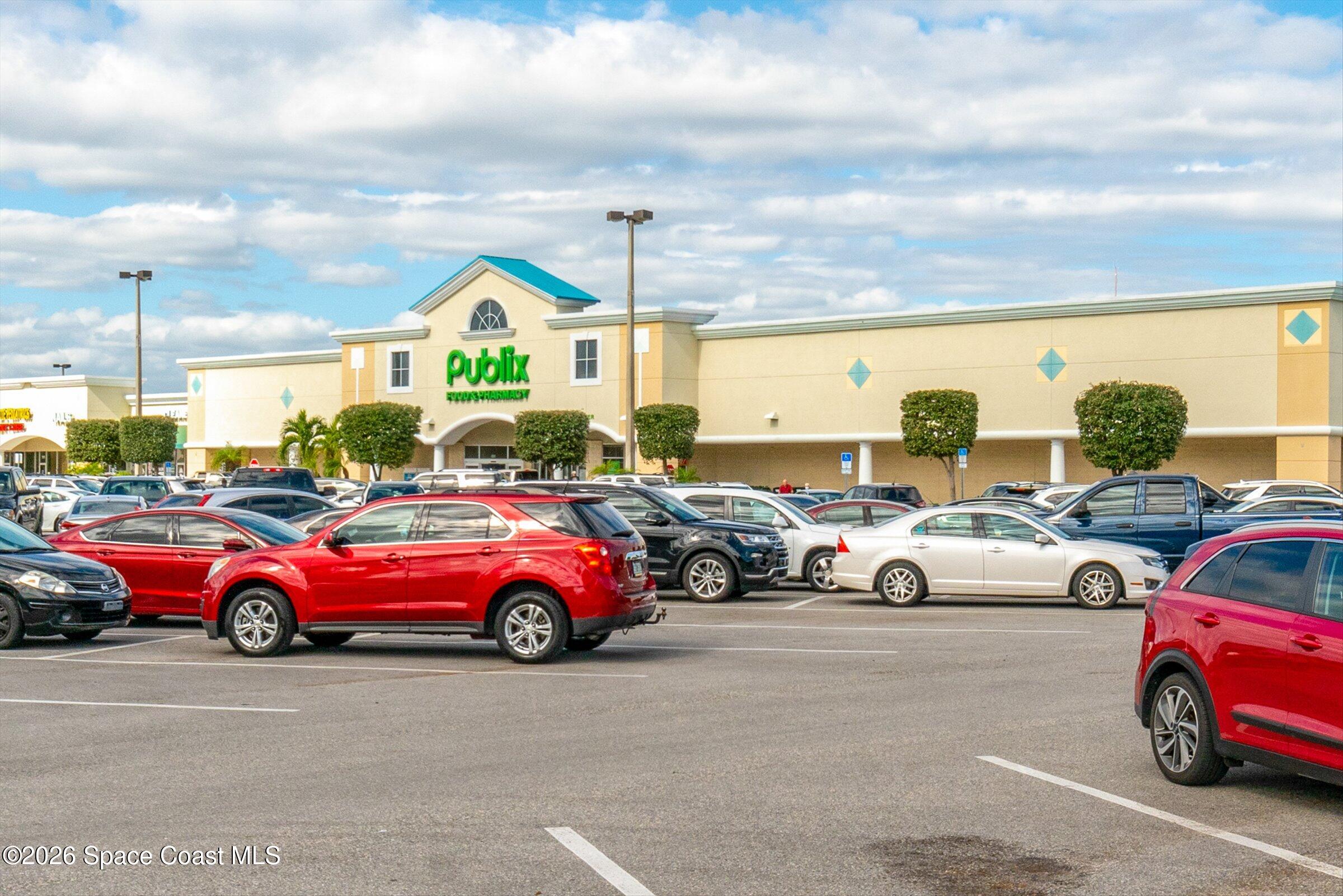 413 Orlov Road Northwest Palm Bay, FL 32907 - Photo 53 of 63 a view of a cars parked in front of a building