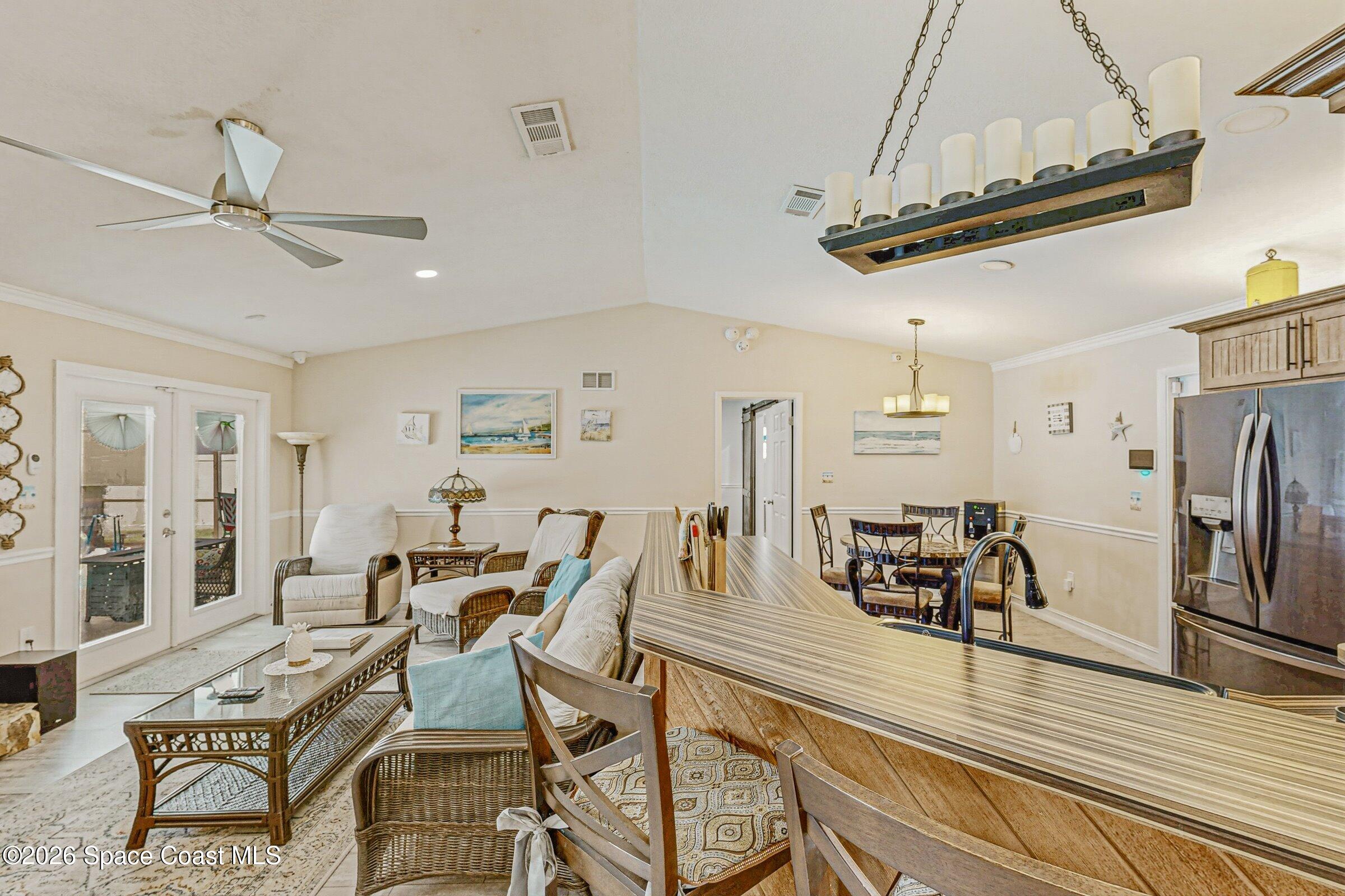 413 Orlov Road Northwest Palm Bay, FL 32907 - Photo 7 of 63 a view of a dining room with furniture a chandelier and wooden floor