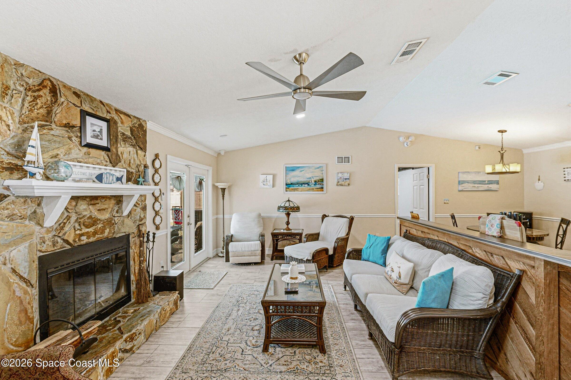 413 Orlov Road Northwest Palm Bay, FL 32907 - Photo 8 of 63 a living room with furniture and a fireplace