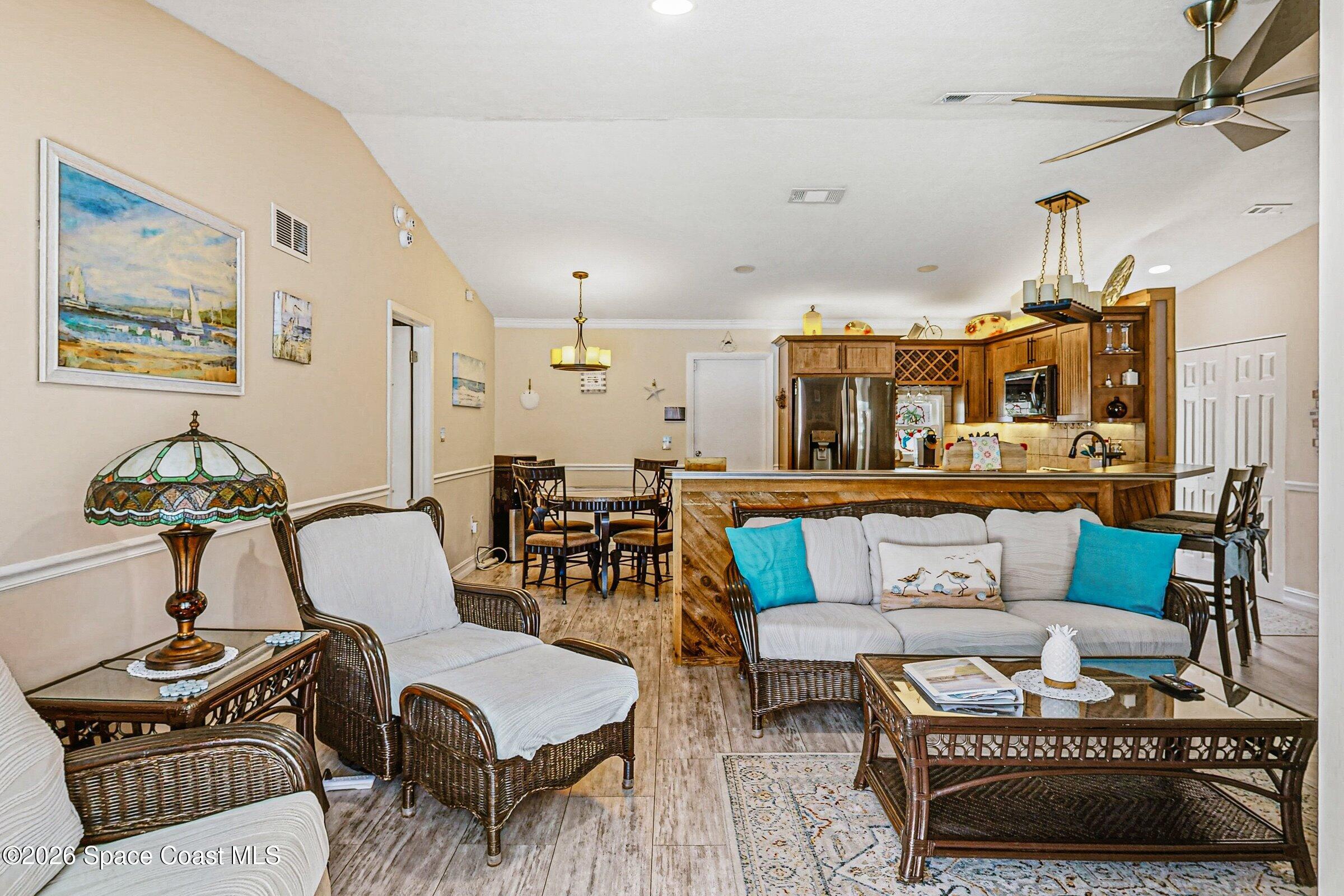 413 Orlov Road Northwest Palm Bay, FL 32907 - Photo 10 of 63 a living room with furniture and a chandelier