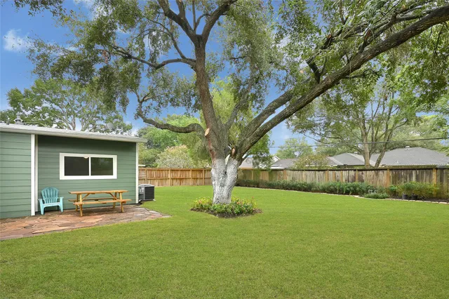 a view of backyard with a garden and outdoor seating