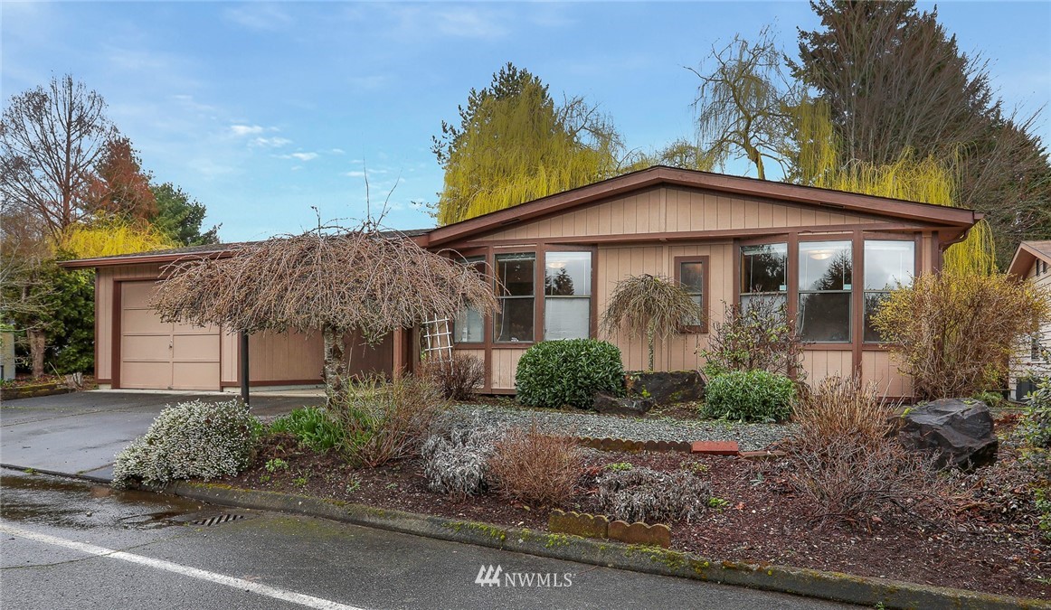 24031 10th Place West Bothell, WA 98021 - Photo 1 of 32 a front view of a house with garden