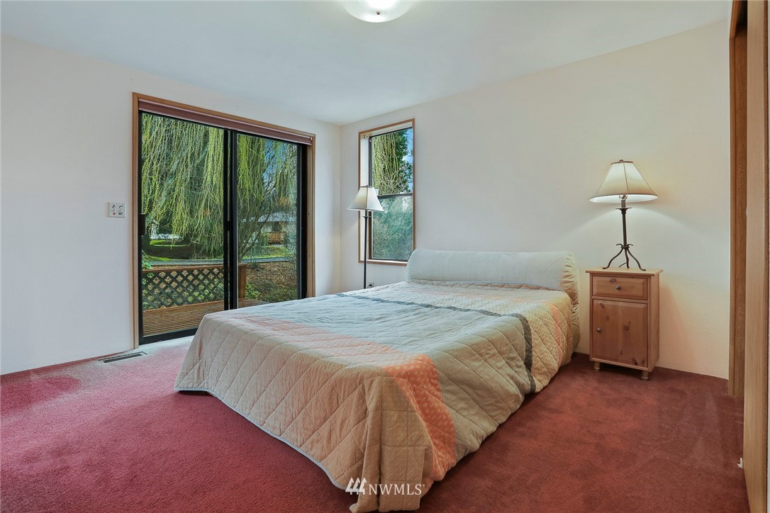 24031 10th Place West Bothell, WA 98021 - Photo 15 of 32 a bed sitting in a bedroom next to a window