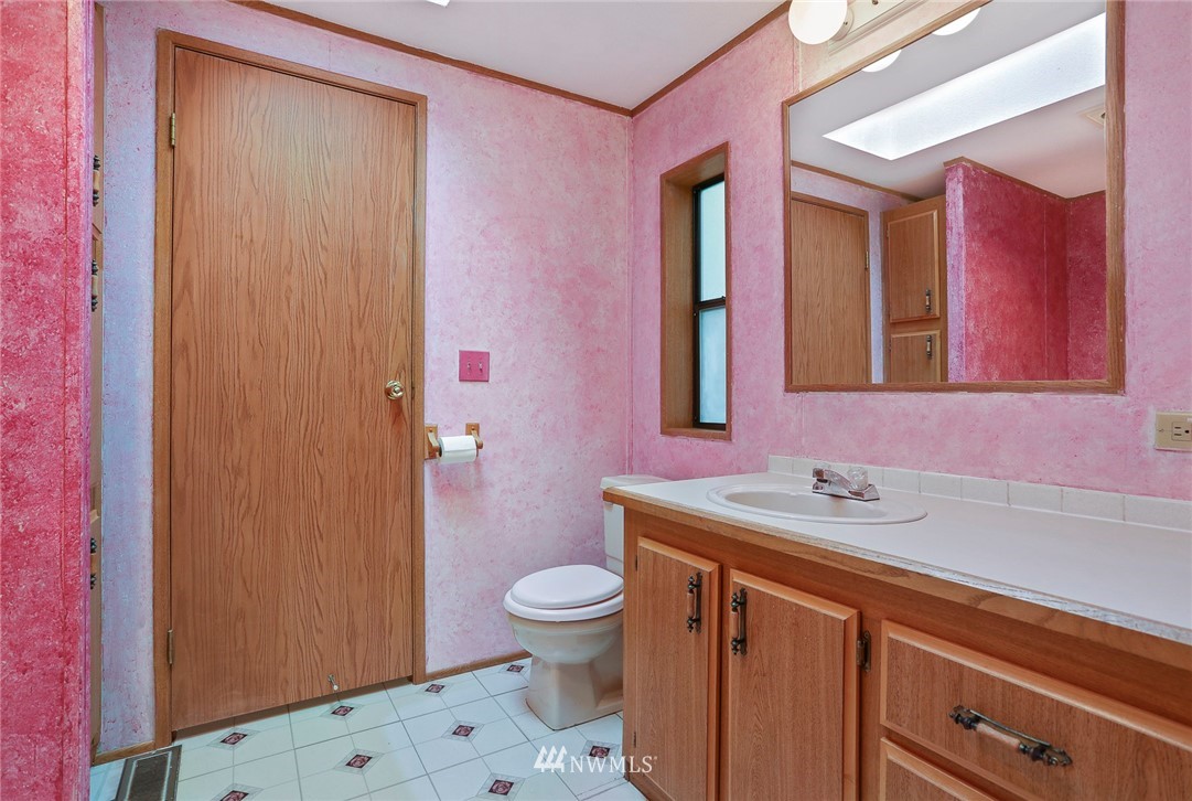 24031 10th Place West Bothell, WA 98021 - Photo 17 of 32 a bathroom with a sink a toilet a mirror and shower