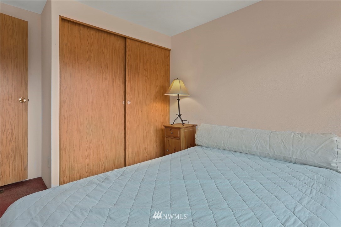 24031 10th Place West Bothell, WA 98021 - Photo 19 of 32 a bedroom with a bed and a lamp