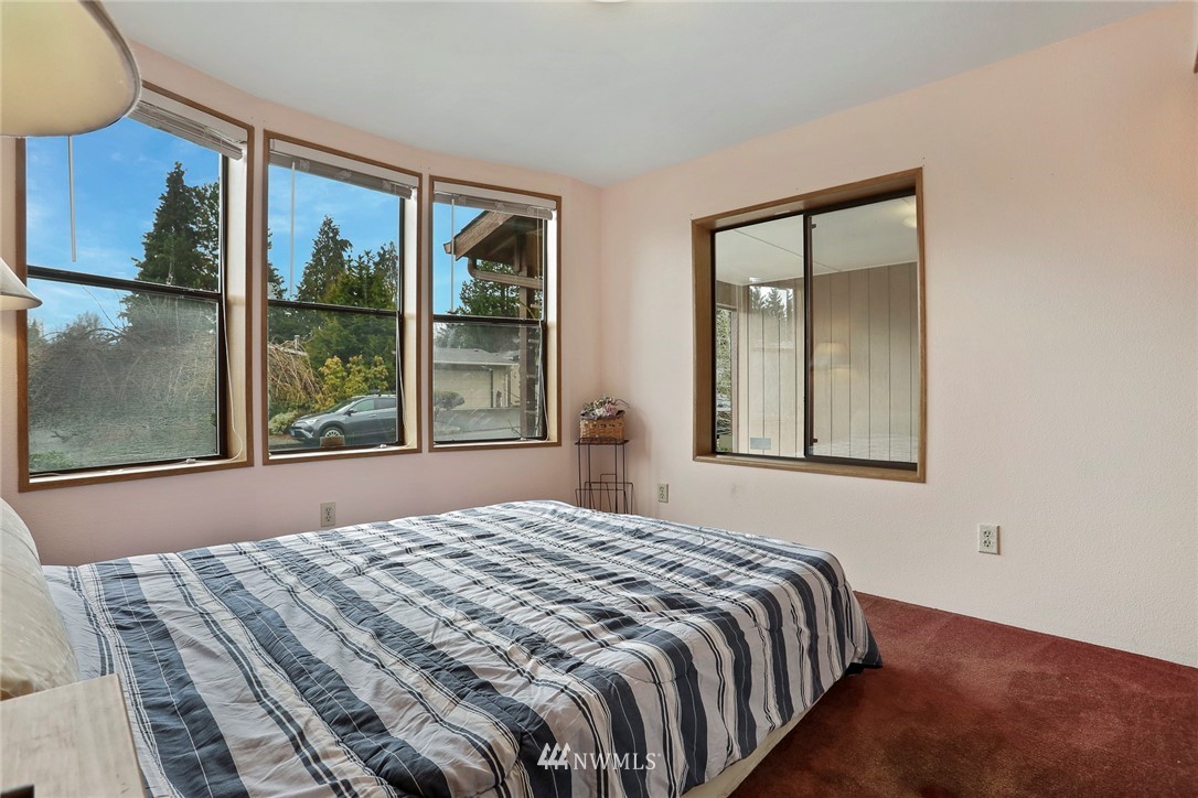 24031 10th Place West Bothell, WA 98021 - Photo 21 of 32 a bedroom with a bed and a large window