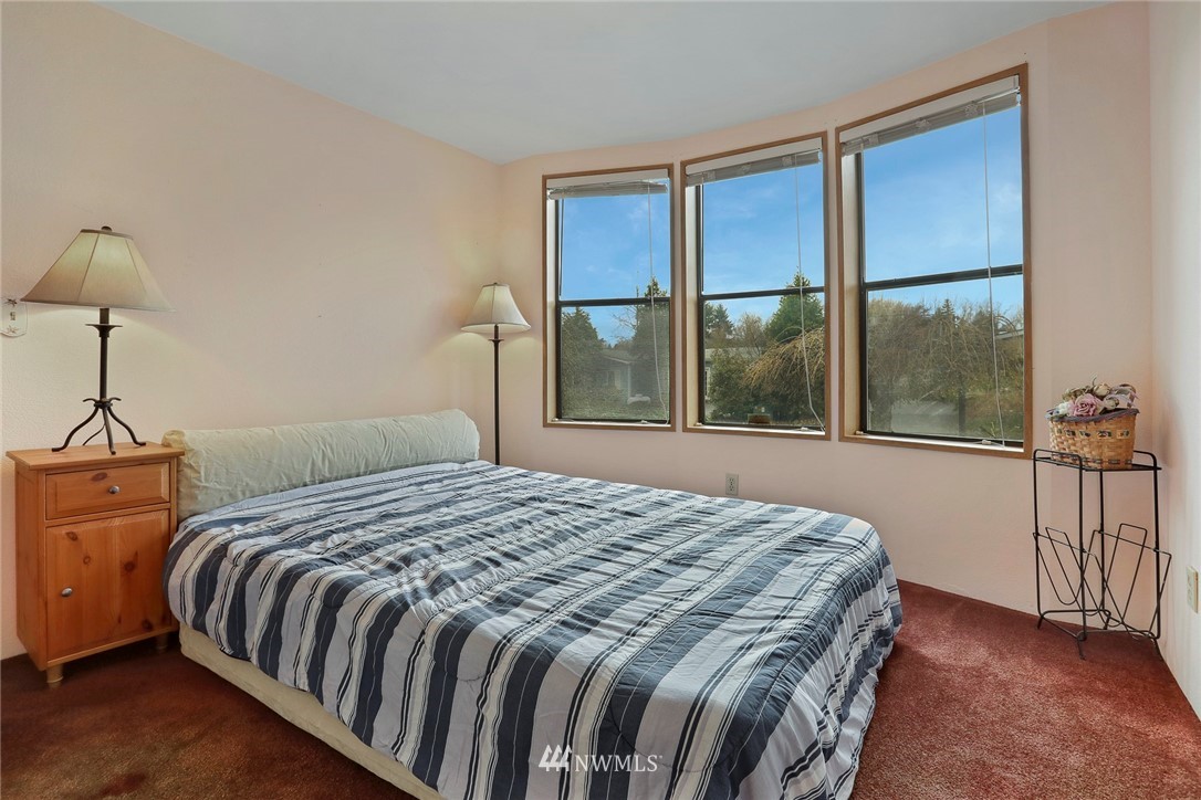 24031 10th Place West Bothell, WA 98021 - Photo 22 of 32 a bedroom with a large bed and a window