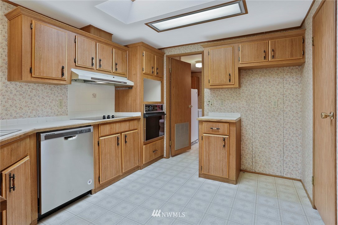 24031 10th Place West Bothell, WA 98021 - Photo 10 of 32 a kitchen with stainless steel appliances granite countertop a refrigerator sink and stove