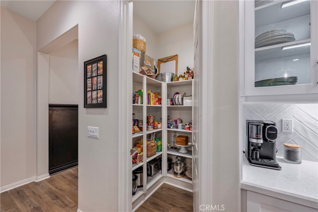 4124 Cameron Way Corona, CA 92883 - Photo 25 of 76 a room with a book shelf and a shelf
