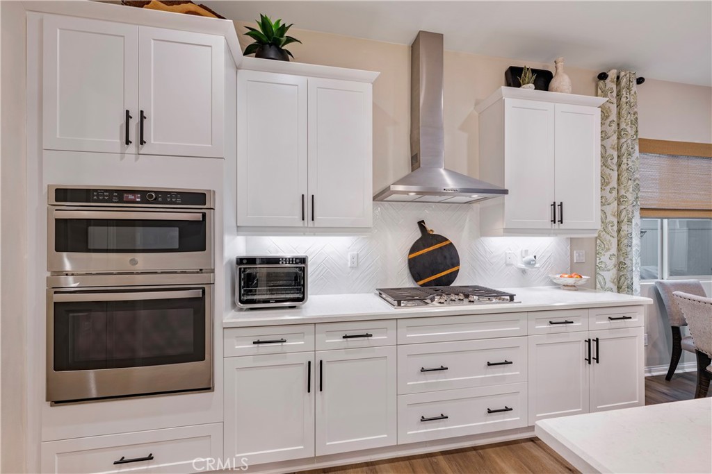 4124 Cameron Way Corona, CA 92883 - Photo 28 of 76 a kitchen with stainless steel appliances white cabinets and a stove
