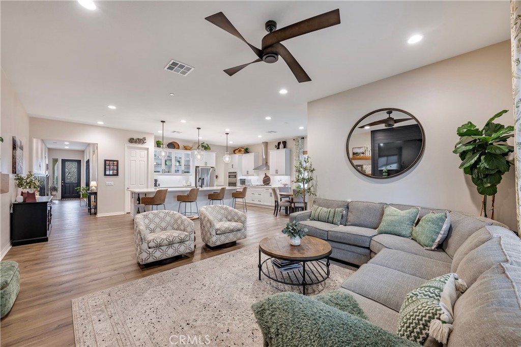 4124 Cameron Way Corona, CA 92883 - Photo 37 of 76 a living room with furniture and a large mirror