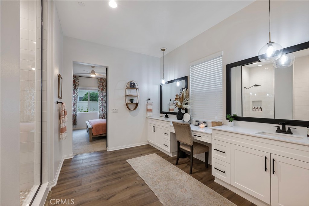 4124 Cameron Way Corona, CA 92883 - Photo 47 of 76 a en suite bathroom with a double vanity sink a large mirror and shower