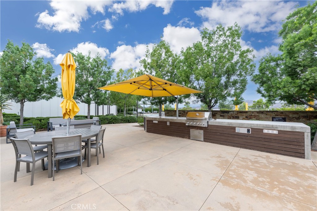 4124 Cameron Way Corona, CA 92883 - Photo 55 of 76 a view of a patio with a table and chairs under an umbrella
