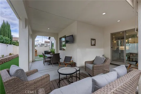 a living room with couches and a dining table with garden view