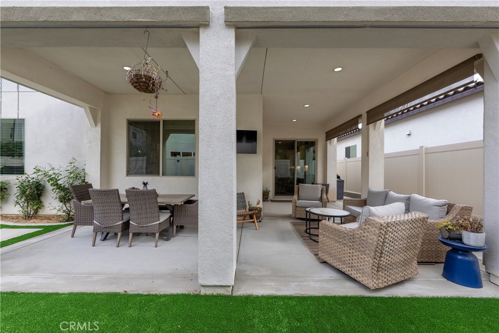 4124 Cameron Way Corona, CA 92883 - Photo 9 of 76 a living room with couches and a dining table with garden view