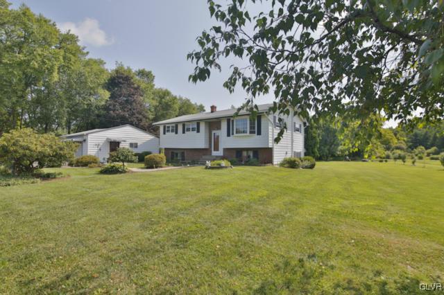 1280 Seifert Road Nazareth, PA 18064 - Photo 2 of 49 a front view of a house with a garden and trees