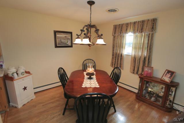 1280 Seifert Road Nazareth, PA 18064 - Photo 22 of 49 a dining room with furniture a chandelier and wooden floor