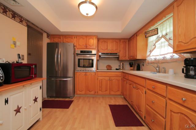 1280 Seifert Road Nazareth, PA 18064 - Photo 27 of 49 a kitchen with granite countertop a refrigerator a sink a stove top oven and cabinets