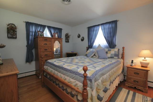 1280 Seifert Road Nazareth, PA 18064 - Photo 35 of 49 a bedroom with a bed and wooden floor